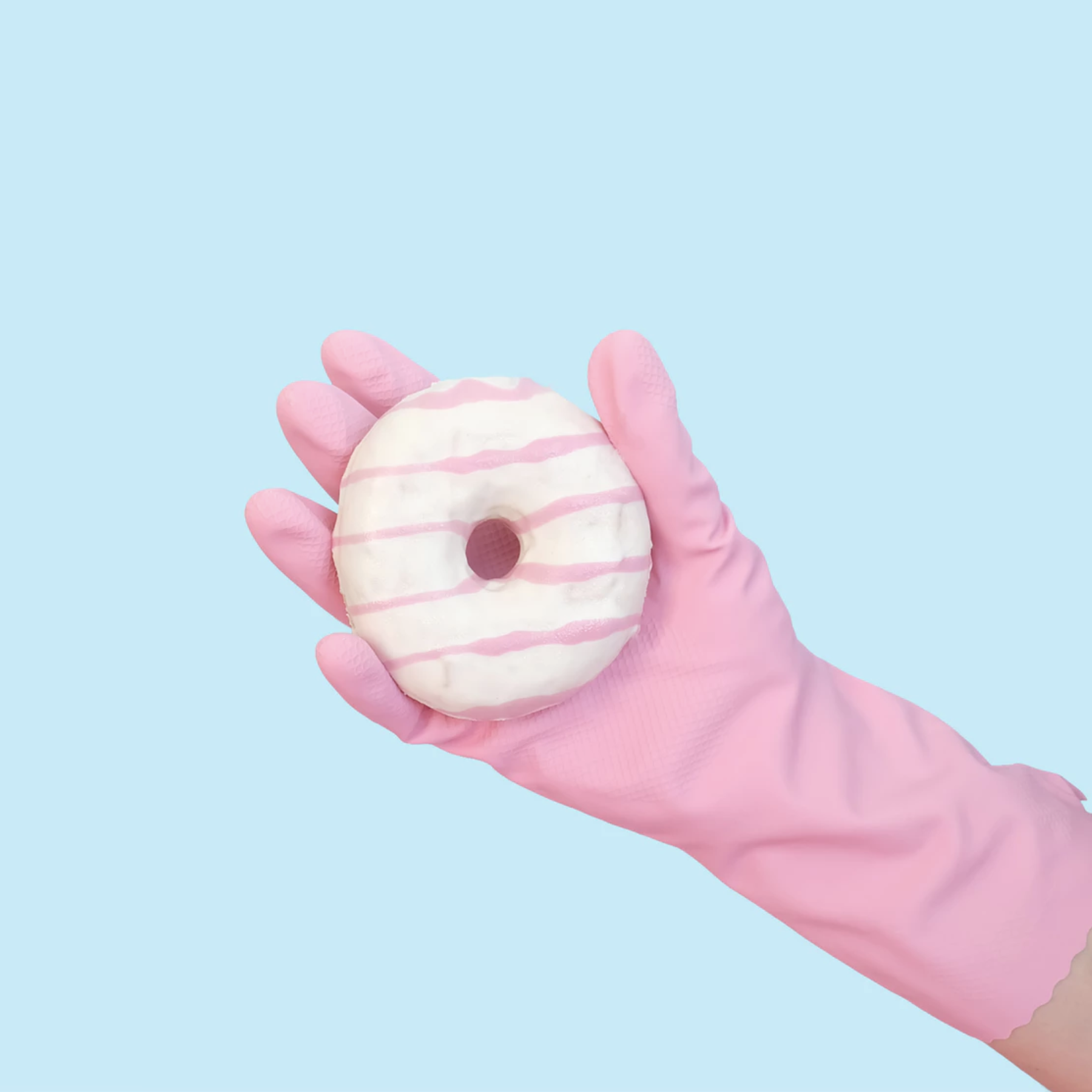 Pink gloved-hang holding a donut